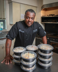 a man in a kitchen with food