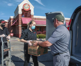 people load meals into a van