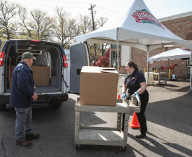 people load meals into a van