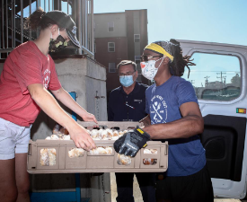 people load meals onto a van