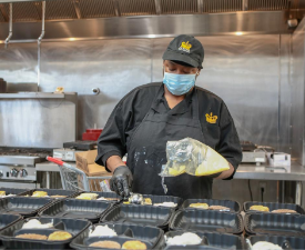 a worker prepares meals