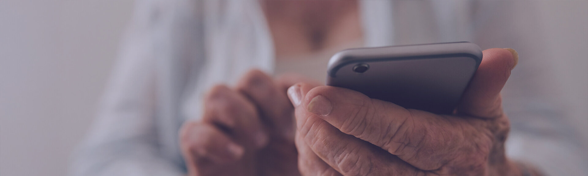 Senior holding phone