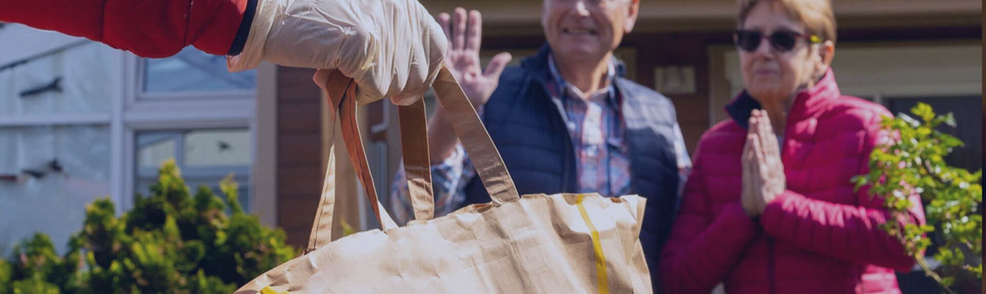 Seniors receiving groceries from a professional service