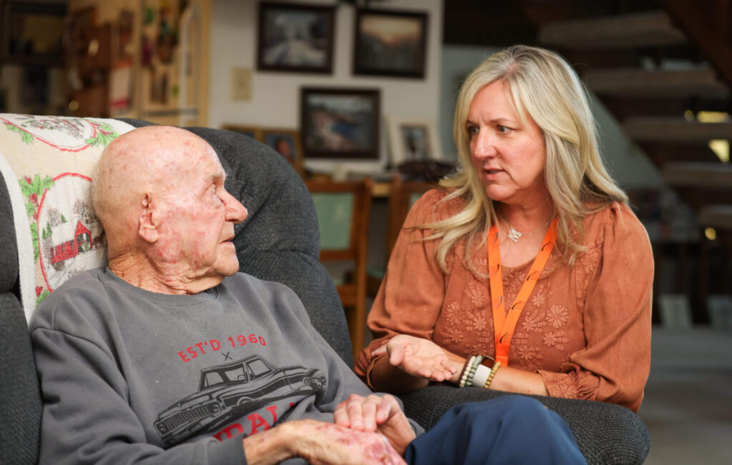 Senior man and adult woman talk at home