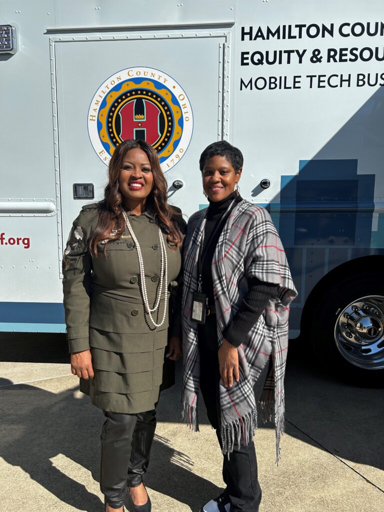 Women standing with the 513Relief bus