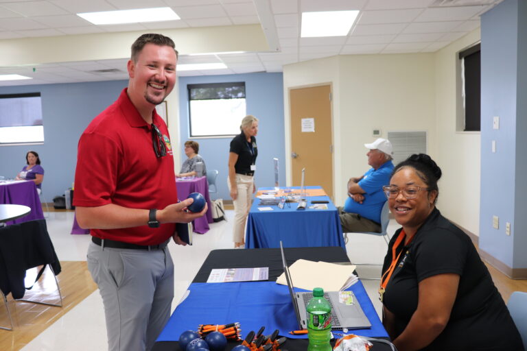 Woman sitting at tabling event with guest