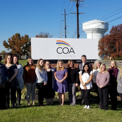 COA Team in front of COA sign