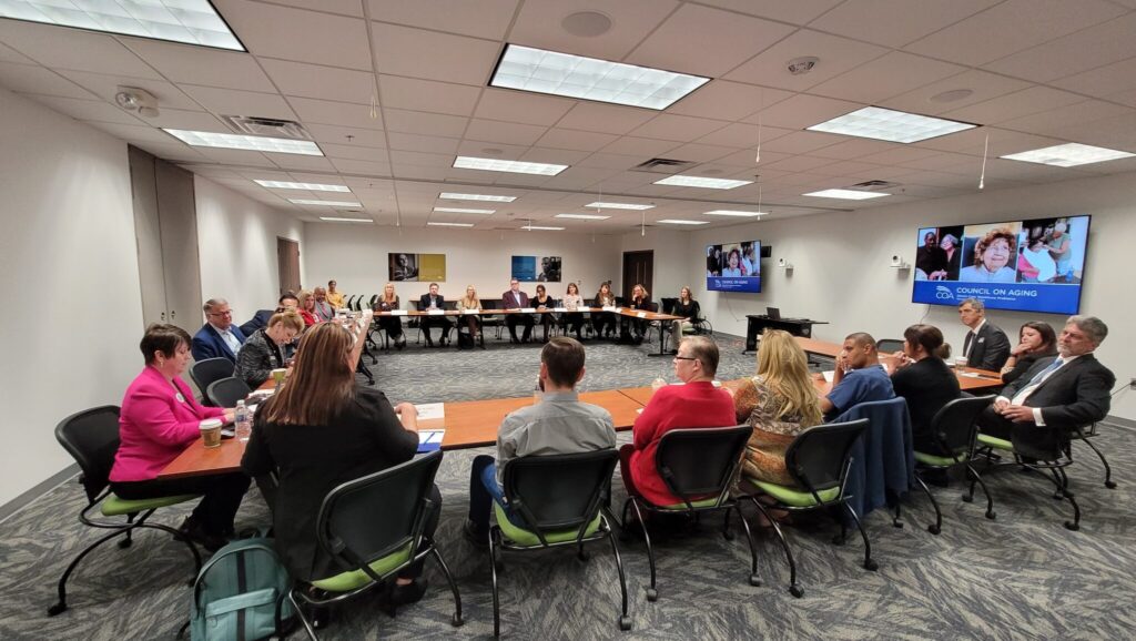 People sit around a table for a conference