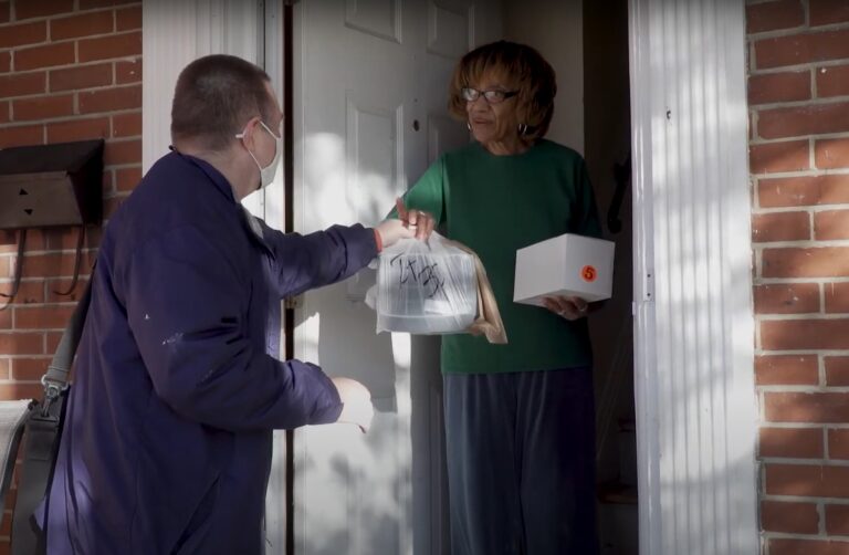 senior woman receives food delivery