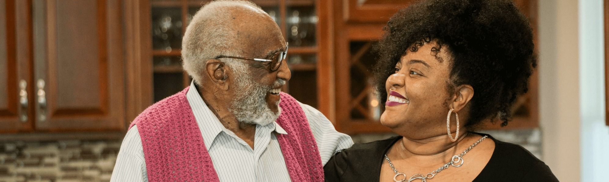 Senior man smiling at younger woman