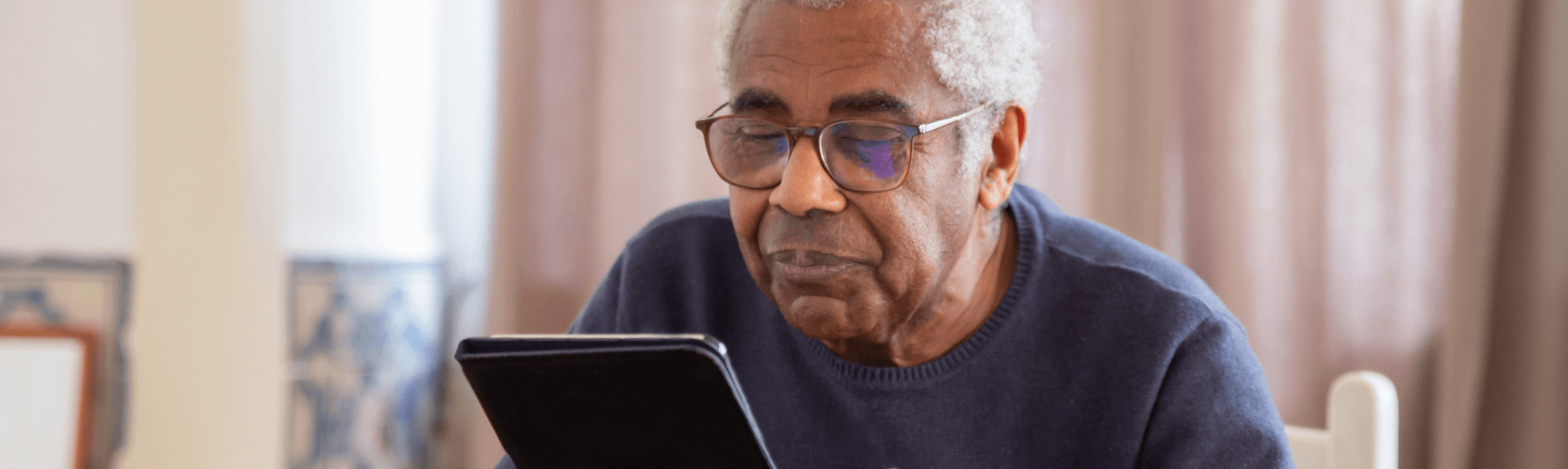 Senior man reading ipad