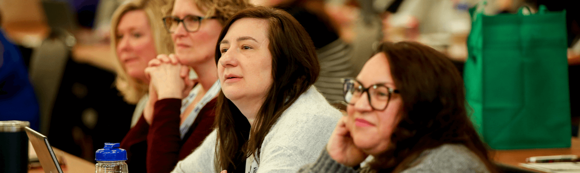 women looking at speaker
