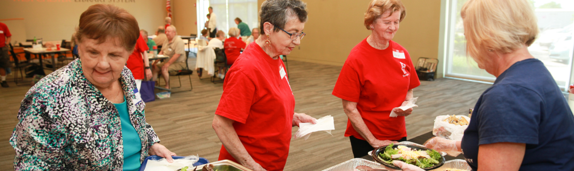Seniors working a buffet