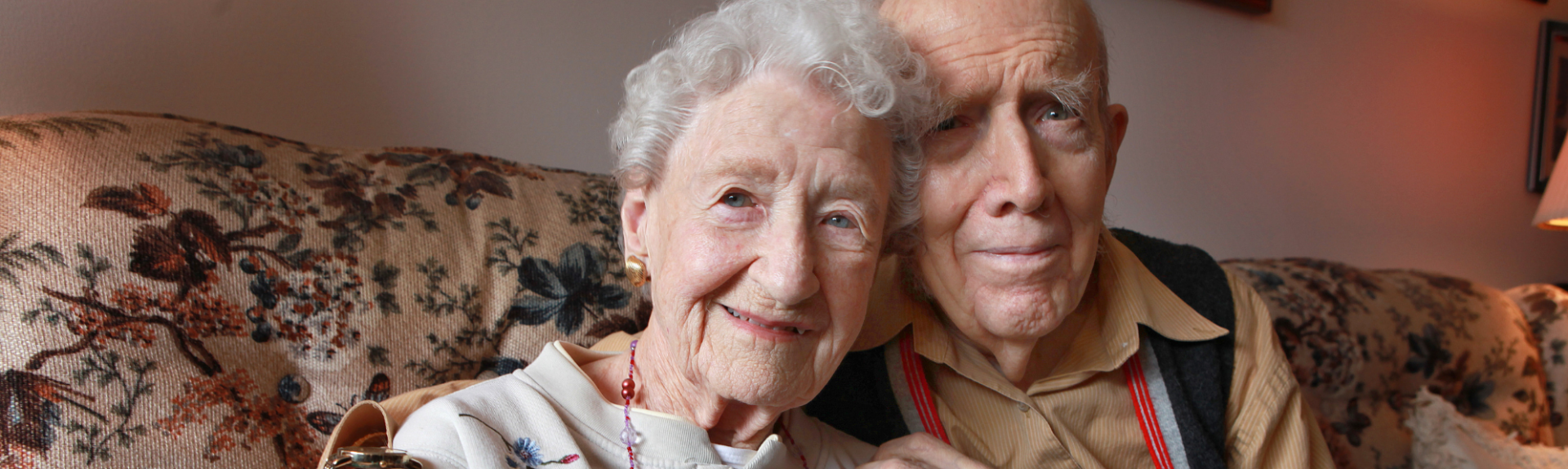 Senior couple sits close together