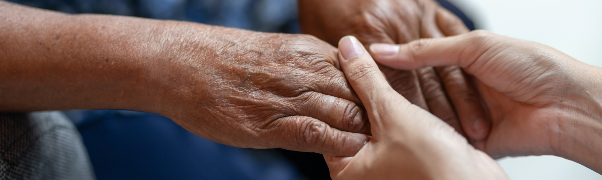 Close up with two people holding hands