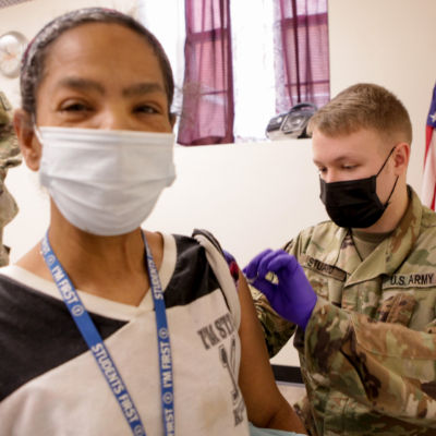 Woman receives vaccine by army man