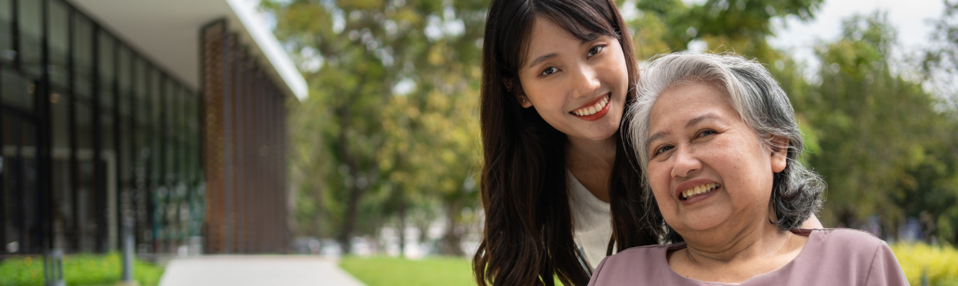 Senior woman and caregiver smiling