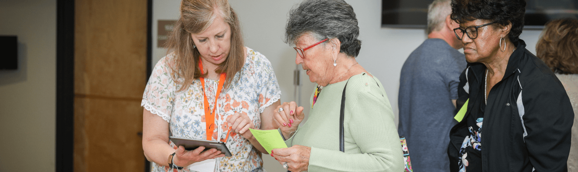 COA volunteer explaining information to senior woman