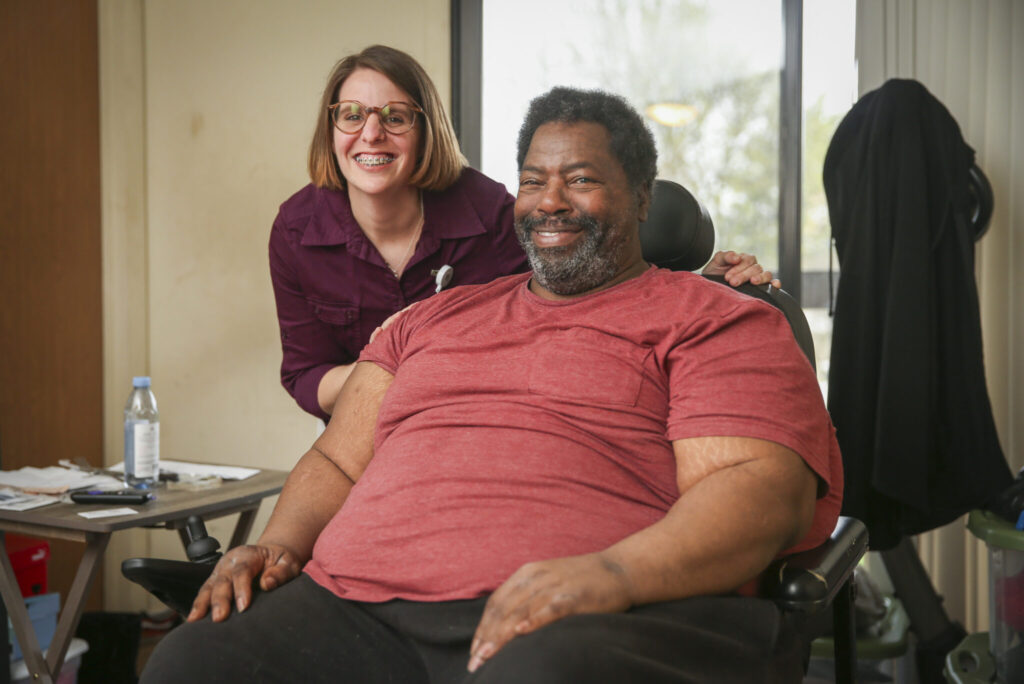 Senior man in a wheel chair and his caregiver