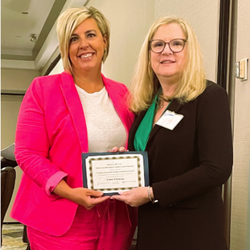 Two women holding o4a award