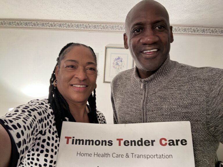 Couple stands with timmons tender care sign
