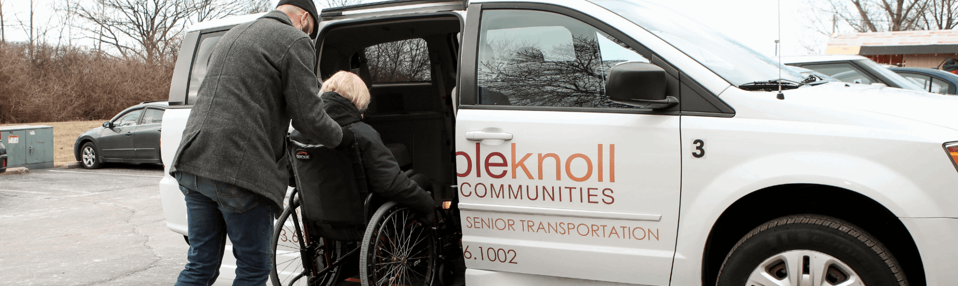 loading senior in wheelchair into transportation van