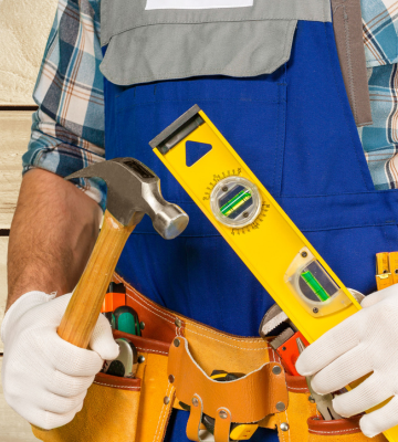 Handyman holding hammer and level