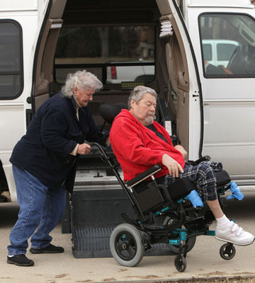 woman helps man in wheelchair