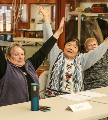 women lifting arms over head